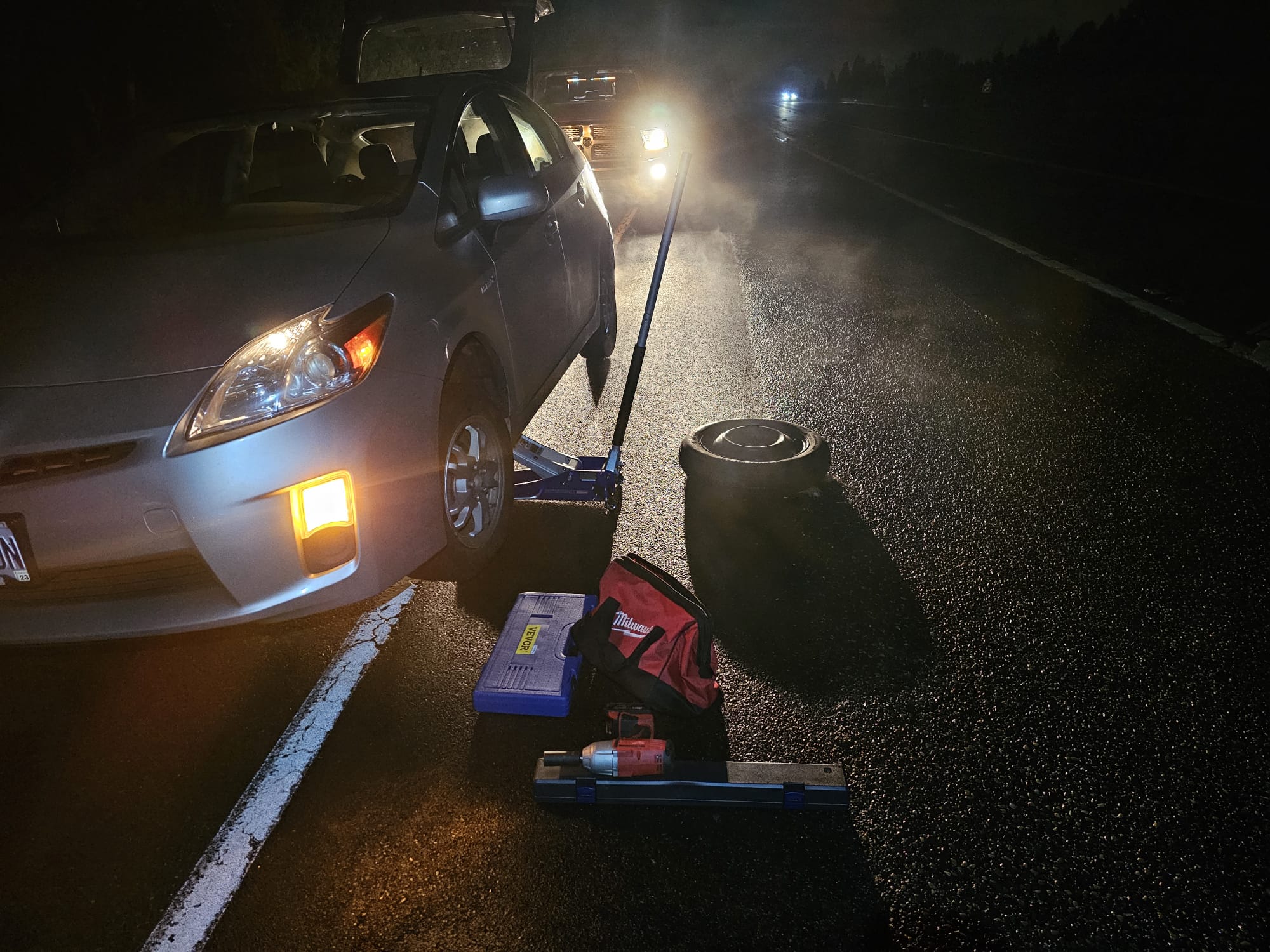 Emergency roadside assistance - tire change on Prius at night